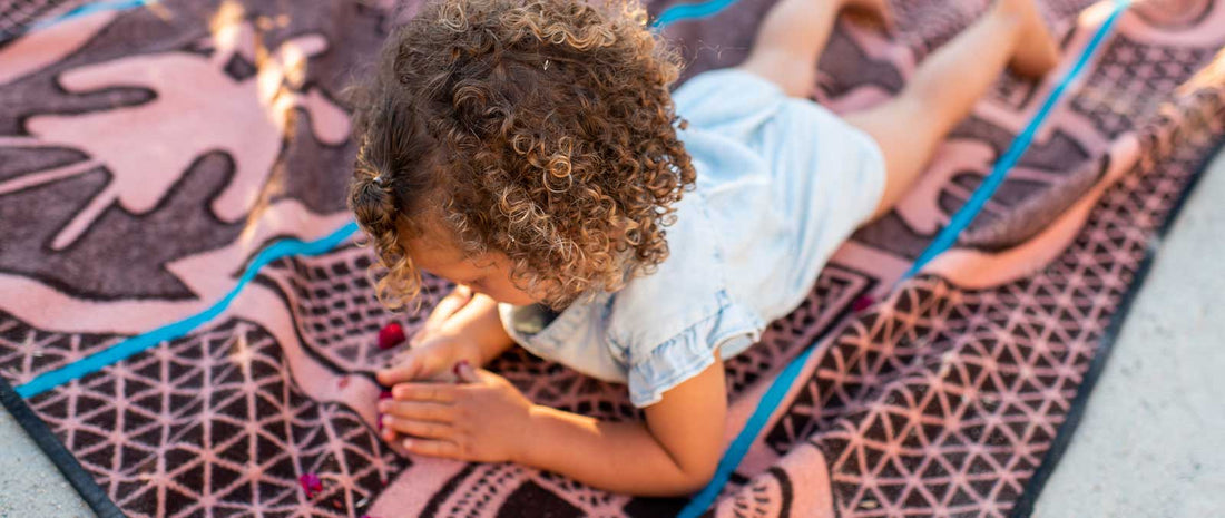 five main benefits of a wool blanket a young girl lays on a Basotho heritage wool blanket 