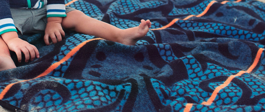 kids sitting on wool blanket