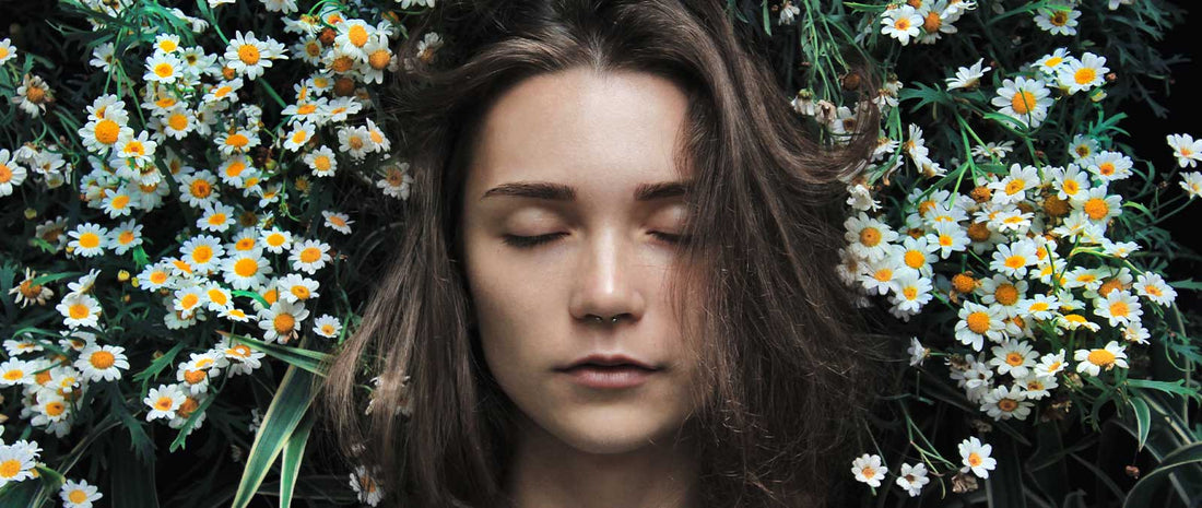 Young women sleeping in bed of flowers and definitely does not have Sleep deprivation