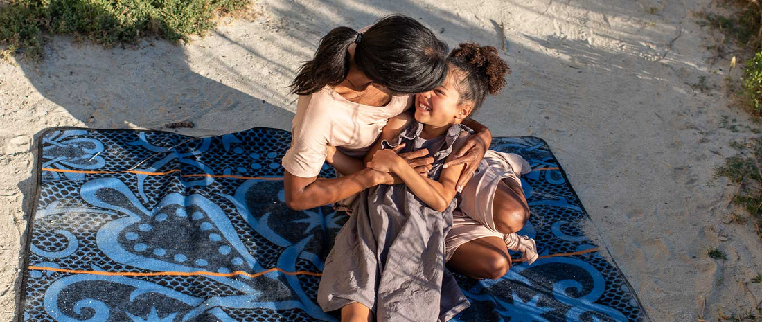 Why the Basotho Wear Blankets Young child and mother embracing on a Basotho heritage blanket